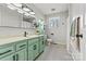 Inviting bathroom with modern fixtures, dual sinks, and green vanity with sleek hardware at 1140 Knollwood Dr, Claremont, NC 28610