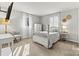 Neutral bedroom featuring a four-post bed, plush chair, and plenty of natural light at 1140 Knollwood Dr, Claremont, NC 28610