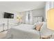 Bright bedroom featuring a four-post bed, wall-mounted TV, and a neutral color palette at 1140 Knollwood Dr, Claremont, NC 28610