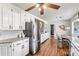 Bright kitchen featuring stainless steel appliances, white cabinetry, and hardwood floors at 1140 Knollwood Dr, Claremont, NC 28610