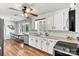 Bright kitchen with white cabinets, stainless steel appliances, and hardwood flooring at 1140 Knollwood Dr, Claremont, NC 28610