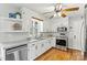 Well-lit kitchen boasts stainless appliances, hardwood floors and white cabinets at 1140 Knollwood Dr, Claremont, NC 28610