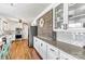 Stylish kitchen with white cabinetry, brick wall, and stainless steel appliances at 1140 Knollwood Dr, Claremont, NC 28610