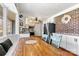 Eat-in kitchen featuring white cabinets, brick accents, and a dining area with great natural light at 1140 Knollwood Dr, Claremont, NC 28610