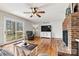 Comfortable living room with fireplace, hardwood flooring, and ample natural light at 1140 Knollwood Dr, Claremont, NC 28610