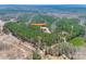 An aerial shot displays a home located on a large wooded lot, highlighting the property's vast acreage at 1370 Martin Rd, Hickory Grove, SC 29717