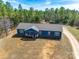 Aerial view of a blue home on a sprawling green lawn, accented by mature trees and a long gravel driveway at 1370 Martin Rd, Hickory Grove, SC 29717