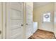 Hallway leading to the laundry room with a washer and dryer near an entry door at 1370 Martin Rd, Hickory Grove, SC 29717