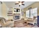 Cozy living room with hardwood floors, a fireplace, and built-in bookshelves at 1370 Martin Rd, Hickory Grove, SC 29717