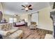 Spacious main bedroom features a decorative fireplace, a ceiling fan, and a sliding barn door at 1370 Martin Rd, Hickory Grove, SC 29717