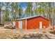 A spacious red metal outbuilding is perfect for storage and hobbies, with room for equipment at 1370 Martin Rd, Hickory Grove, SC 29717