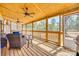 A covered porch offers outdoor living space with wood floors and screens, blending indoor comfort with nature at 1370 Martin Rd, Hickory Grove, SC 29717