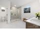 Bright bathroom featuring a tiled shower, white marble counters, and a window with a wooded view at 1465 Highcrest Way, Rock Hill, SC 29730