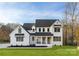 Charming two-story modern farmhouse with black frame windows and a cozy front porch at 1465 Highcrest Way, Rock Hill, SC 29730