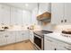 Modern kitchen featuring white cabinets, stainless steel appliances, quartz countertops, and hardwood floors at 1465 Highcrest Way, Rock Hill, SC 29730