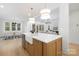 Bright kitchen featuring a farmhouse sink, quartz countertops, and open layout to dining and living areas at 1465 Highcrest Way, Rock Hill, SC 29730