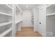 Spacious walk-in closet with custom shelving and wood floors at 1465 Highcrest Way, Rock Hill, SC 29730