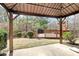 Covered backyard patio featuring a deck, outdoor grill, and serene views of the surrounding greenery at 147 Amber Woods Dr, Tega Cay, SC 29708