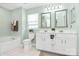 Bathroom with double sinks, tub and shower combo, and lots of natural light at 147 Amber Woods Dr, Tega Cay, SC 29708