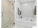 Bright bathroom boasts a large soaking tub and tiled glass-door shower at 147 Amber Woods Dr, Tega Cay, SC 29708