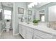 Well-lit bathroom featuring a double sink vanity and decorative wall art at 147 Amber Woods Dr, Tega Cay, SC 29708