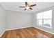 Comfortable bedroom featuring hardwood floors, a ceiling fan, and a bright window at 147 Amber Woods Dr, Tega Cay, SC 29708