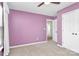 Bright bedroom featuring purple walls and a double door closet at 147 Amber Woods Dr, Tega Cay, SC 29708