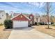 Charming two-story home with brick accents, white garage door, and a well-manicured front yard at 147 Amber Woods Dr, Tega Cay, SC 29708