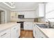 Kitchen with white cabinets, stainless steel appliances, and hardwood floors at 147 Amber Woods Dr, Tega Cay, SC 29708