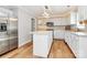 Bright kitchen with white cabinets, stainless steel appliances, and an island with seating at 147 Amber Woods Dr, Tega Cay, SC 29708