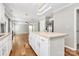 Kitchen island that connects to the living room, hardwood floors, and plenty of sunlight at 147 Amber Woods Dr, Tega Cay, SC 29708