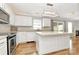 Well-lit kitchen featuring white cabinets, stainless steel appliances, and a center island with seating at 147 Amber Woods Dr, Tega Cay, SC 29708