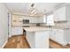 Kitchen featuring white cabinets, stainless steel appliances, hardwood floors, and a center island at 147 Amber Woods Dr, Tega Cay, SC 29708