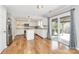 Modern kitchen with hardwood floors, white cabinets, stainless steel appliances, and a sliding door to backyard at 147 Amber Woods Dr, Tega Cay, SC 29708