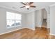 Inviting living room with hardwood floors, a ceiling fan, and staircase access at 147 Amber Woods Dr, Tega Cay, SC 29708