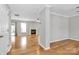 Spacious living room with hardwood floors featuring a fireplace and windows to the backyard at 147 Amber Woods Dr, Tega Cay, SC 29708