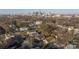 An aerial perspective highlighting the house, neighborhood streets, and skyline for a sense of place within the city at 1509 Harrill St, Charlotte, NC 28205