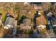 An aerial view showcases the property's location among mature trees, neighboring homes, and proximity to community amenities at 1509 Harrill St, Charlotte, NC 28205