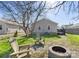 Backyard featuring mature trees, fire pit, and Adirondack chairs at 1509 Harrill St, Charlotte, NC 28205