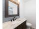 Stylish half-bathroom boasts granite counter, wooden vanity, and tiled wall at 1509 Harrill St, Charlotte, NC 28205