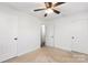 Spacious bedroom with neutral carpet, white walls, and ceiling fan at 1509 Harrill St, Charlotte, NC 28205