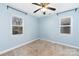 Sunlit bedroom featuring two windows, neutral carpet, and light blue walls at 1509 Harrill St, Charlotte, NC 28205