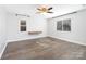 Bright bedroom featuring hardwood floors, large windows, and modern ceiling fan at 1509 Harrill St, Charlotte, NC 28205