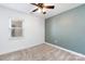 Clean and bright bedroom with neutral carpet, window, and ceiling fan at 1509 Harrill St, Charlotte, NC 28205