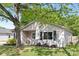 Inviting home with black shutters, a well-kept lawn, and a mature shade tree providing curb appeal at 1509 Harrill St, Charlotte, NC 28205