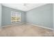 Serene bedroom features a ceiling fan, carpeted floors, and a bright window at 16312 Redstone Mountain Ln, Charlotte, NC 28277