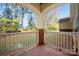 Inviting covered porch with brick detail and views of a wooded landscape, perfect for relaxing at 16312 Redstone Mountain Ln, Charlotte, NC 28277