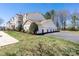 Condominium exterior featuring beige siding and a multi-car garage at 16312 Redstone Mountain Ln, Charlotte, NC 28277