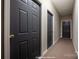 Neutral hallway featuring painted doors and carpeted floors at 16312 Redstone Mountain Ln, Charlotte, NC 28277