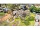 An aerial view of the home, showing a well-kept lawn, mature trees, and detached garage at 1815 W Sugar Creek Rd, Charlotte, NC 28262